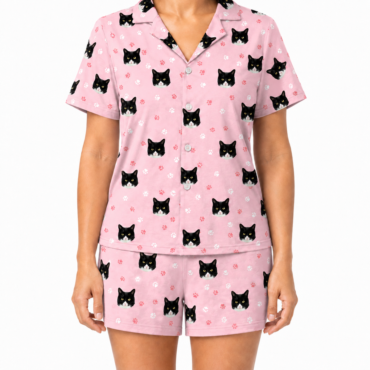 Light pink paws pajama set with black cat pattern on a white background
