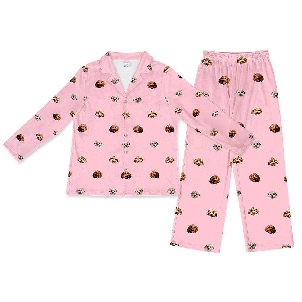 Pink long-sleeve pajama set with matching pants, decorated with a repeating pattern of three different dog faces.