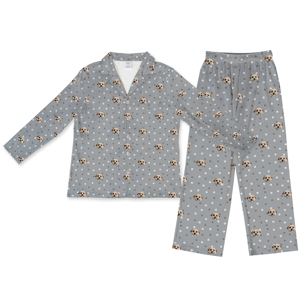 Slate gray long-sleeve pajama set with pants, featuring an all-over repeating pattern of a small, light-colored dog's face with tan and brown markings, interspersed with white and dark gray paw prints.