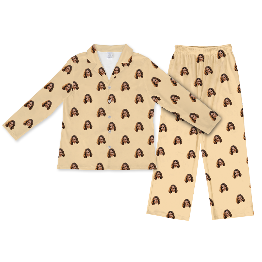 Butter-yellow long-sleeve button-up pajama top with matching pants, featuring a repeating pattern of the same smiling woman’s face printed across the fabric.