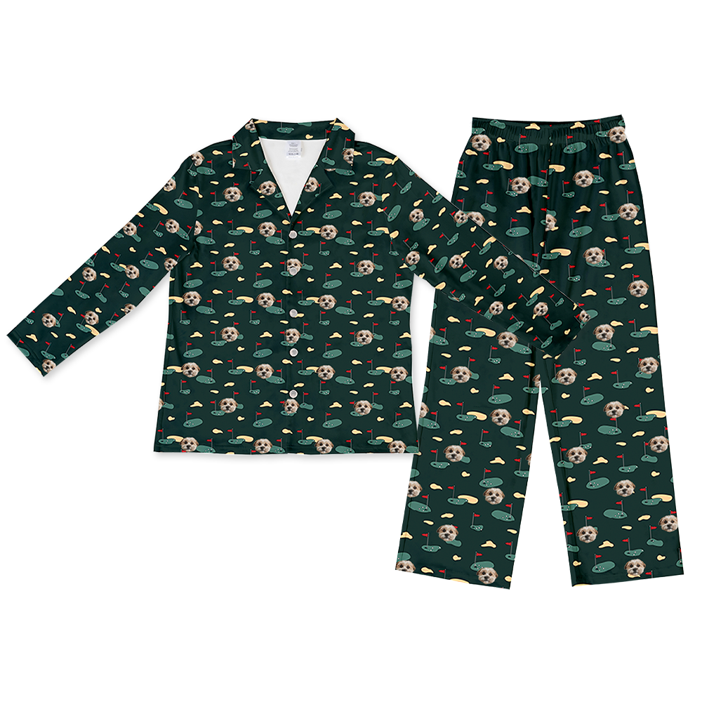 Hunter green two-piece pajama set with a long-sleeve button-down top and matching pants, featuring an all-over golf-themed pattern with dog faces, golf greens, flags, and sand traps.
