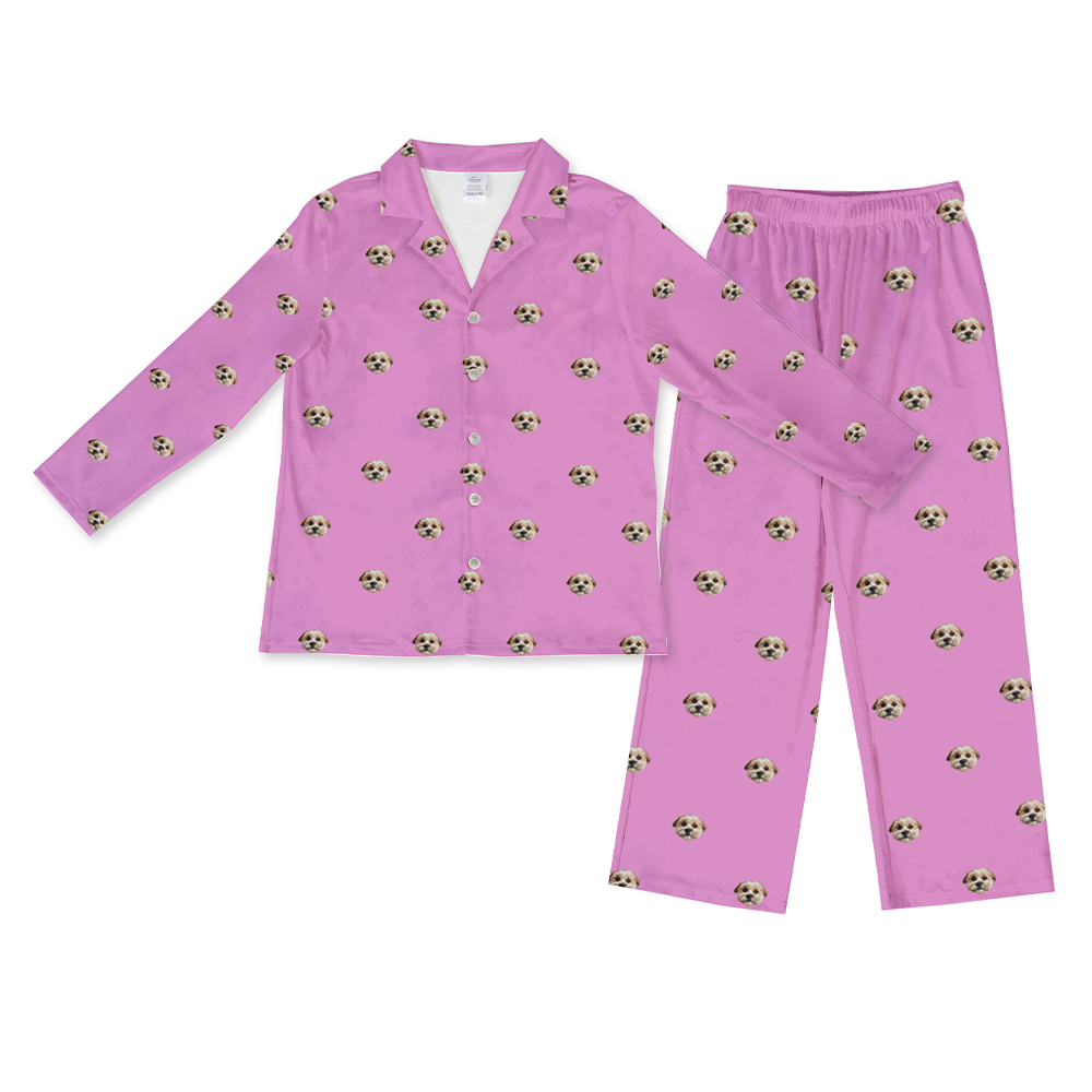 A matching set of long-sleeve, long pajama pants in an orchid color. The set features an all-over repeating pattern of a single small, fluffy dog's face.