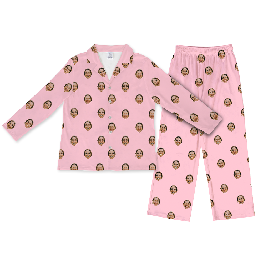 Light pink long-sleeve button-up pajama top with matching pants, decorated with a repeating pattern of the same smiling woman’s face across the fabric.