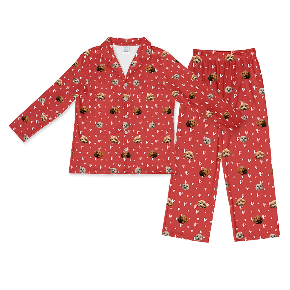 Matching red long-sleeve pajama set with a button-down top and pants, patterned with white hearts and the custom faces of two different dogs.