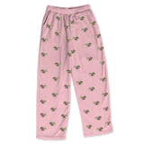 These are pajama pants in a pink color with repeating pet faces on them