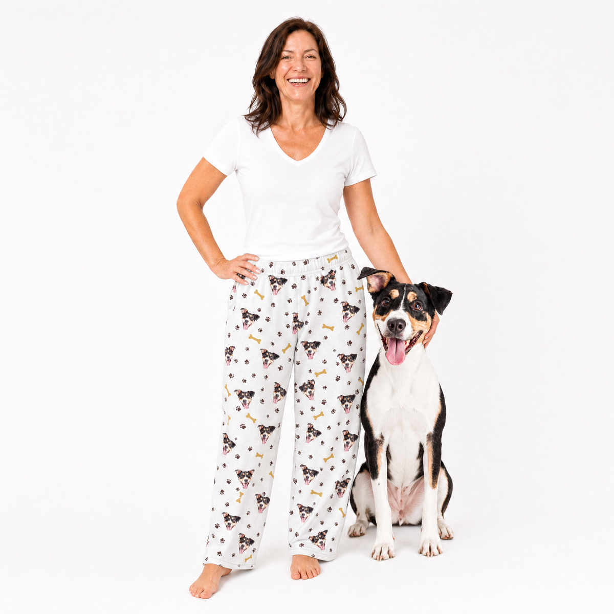 Woman wearing a white t-shirt and patterned pajama pants with a dog on a white background