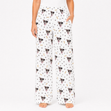 Person wearing white pajama pants with dog pattern on a white background