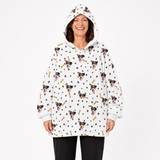 Person wearing a white blanket hoodie with dog pattern on a white background