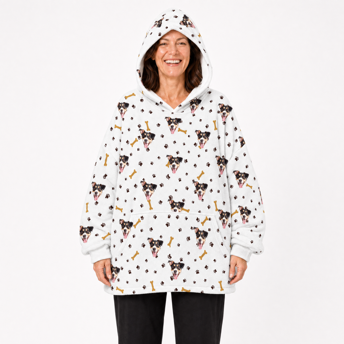 Person wearing a white blanket hoodie with dog pattern on a white background