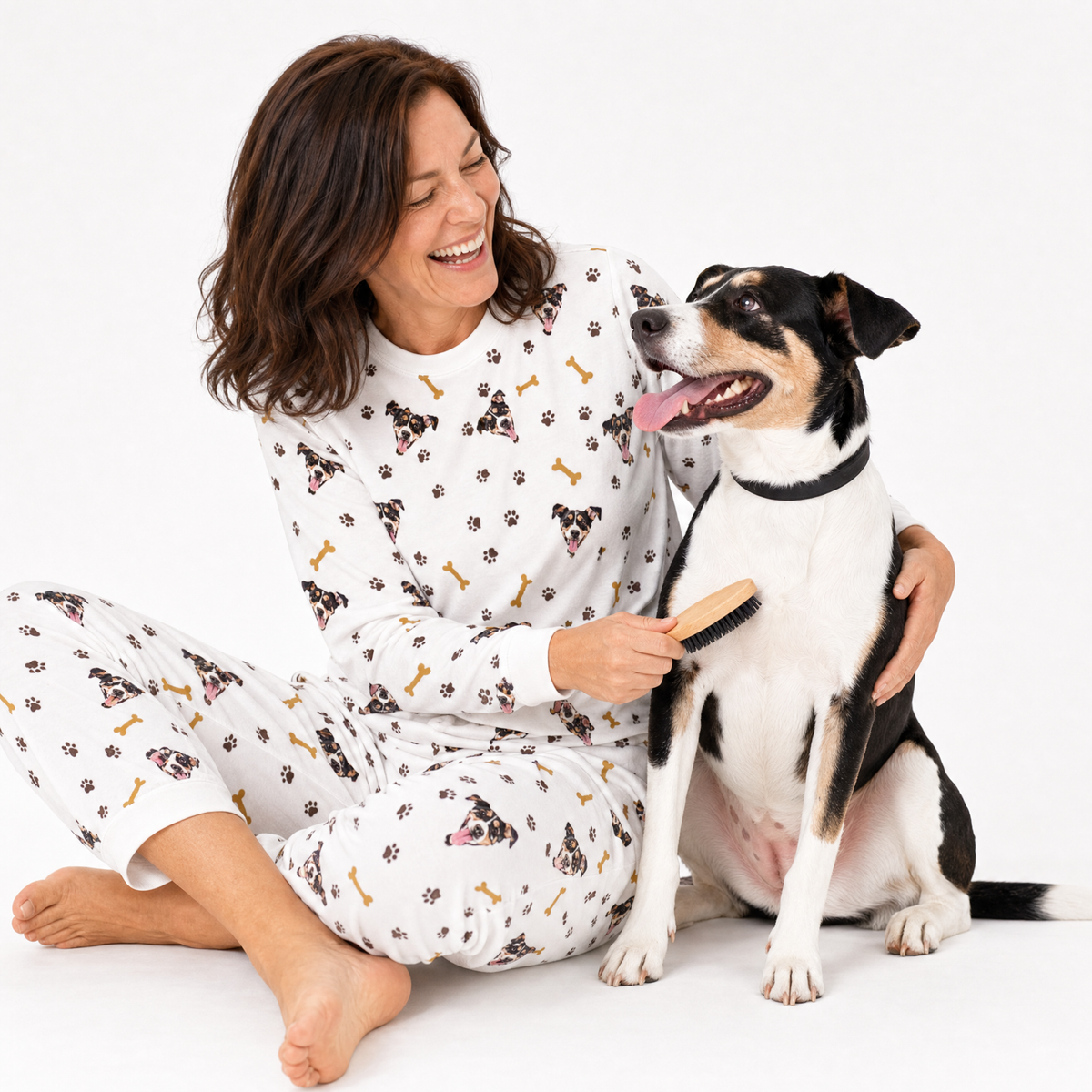 Woman in white jogger pajamas with a dog on a white background