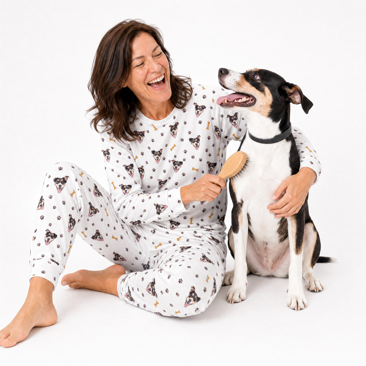 Woman in white jogger pajamas with a dog, sitting on a white background
