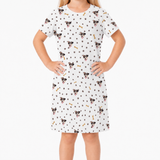 White nightgown with dog pattern worn by a person on a white background