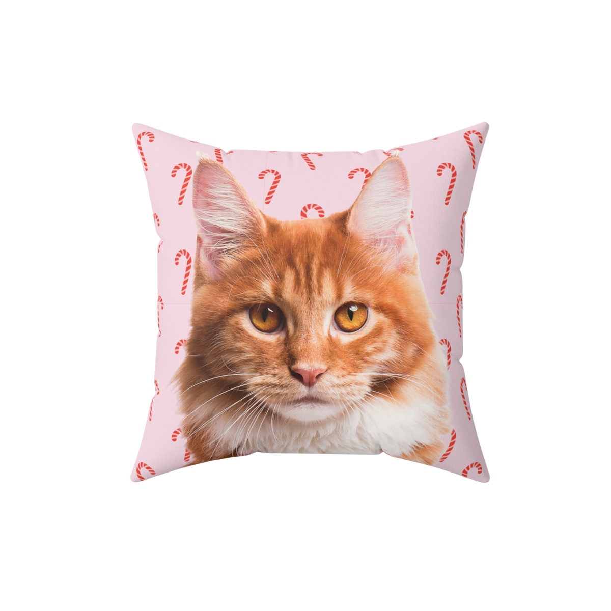 Square throw pillow featuring a realistic orange tabby cat on a light pink background patterned with red candy canes.