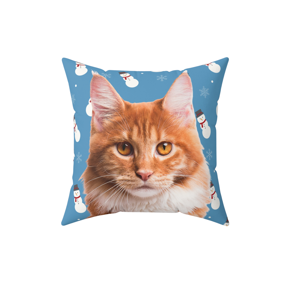 Pillow with a cat's face on a blue background with snowmen