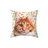 Decorative pillow with a cat face and christmas lights background
