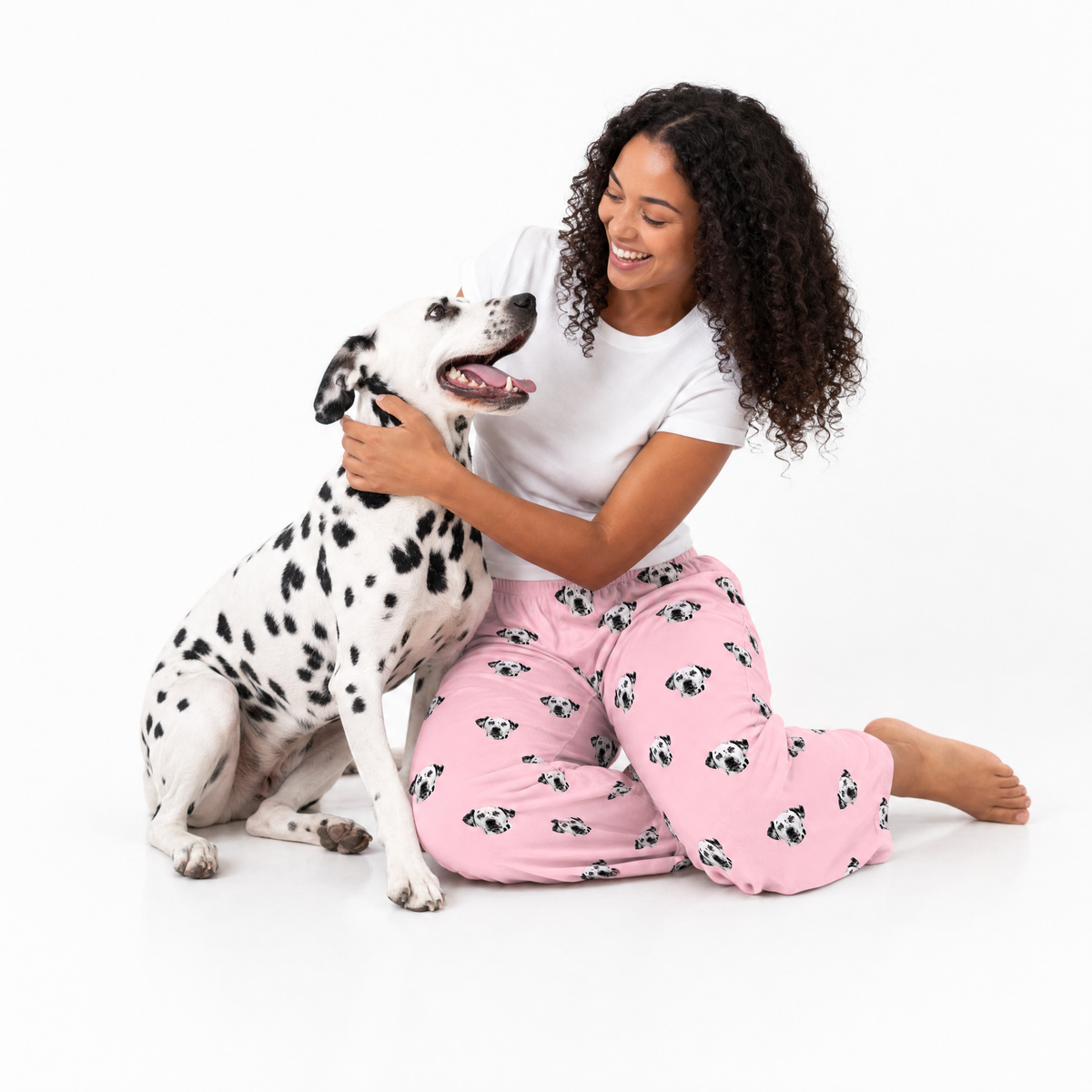 Pink Dream theme – person in Dalmatian-print pajamas hugging Dalmatian dog.