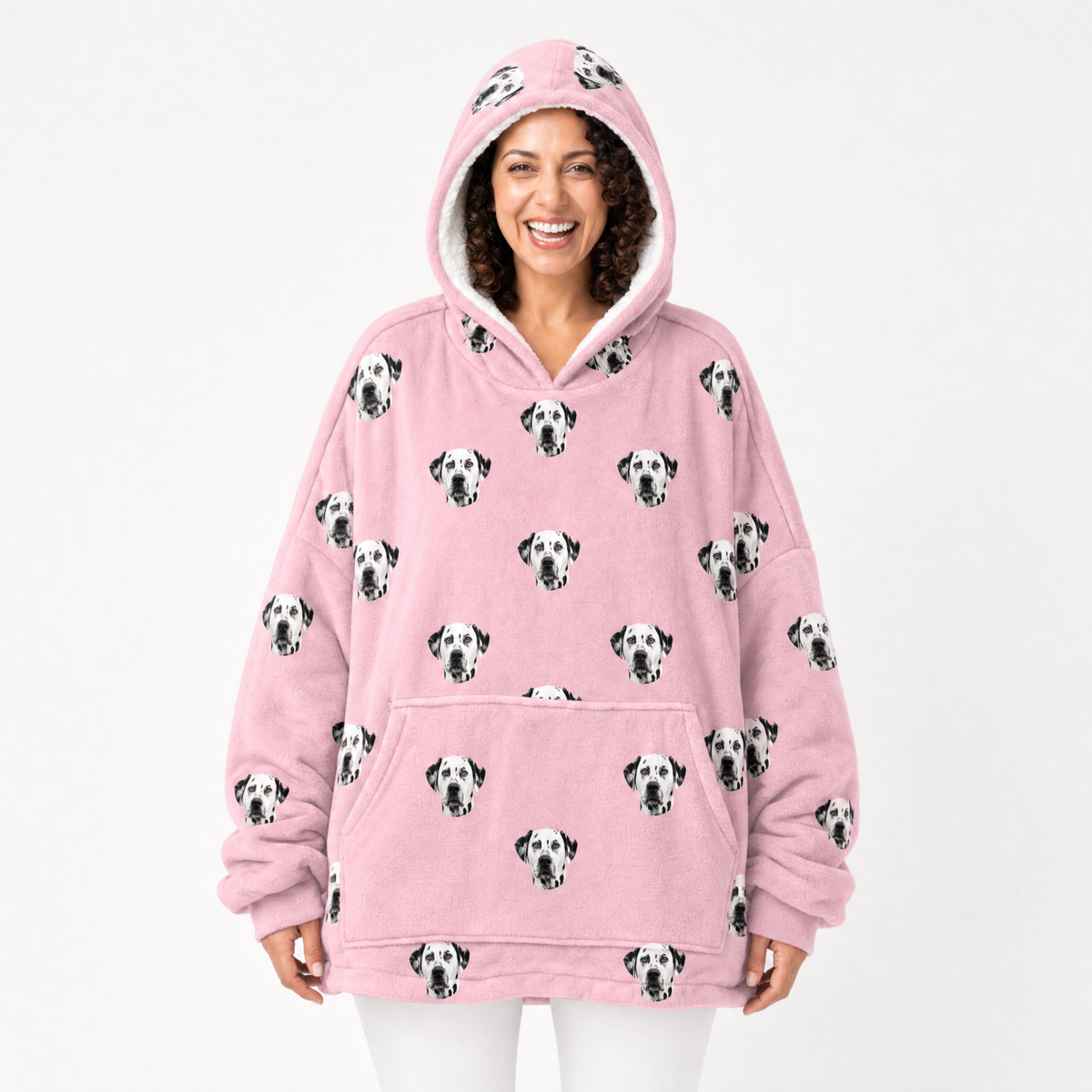 Person wearing a pink blanket hoodie with Dalmatian dog pattern on a white background