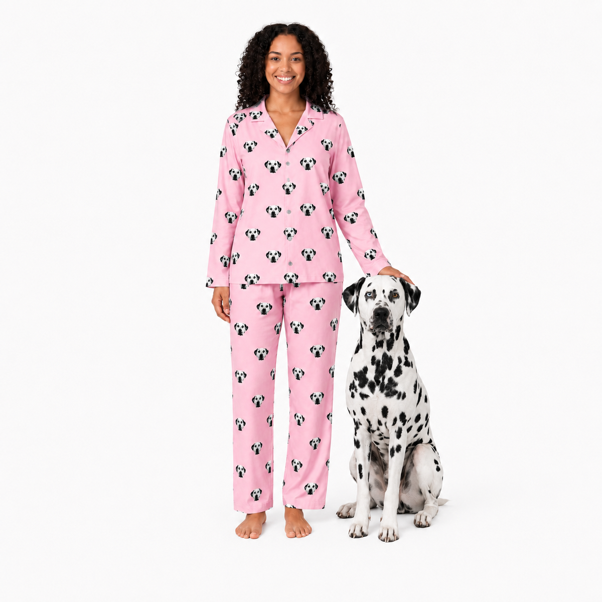 Woman wearing pink pajamas with a dog on a white background