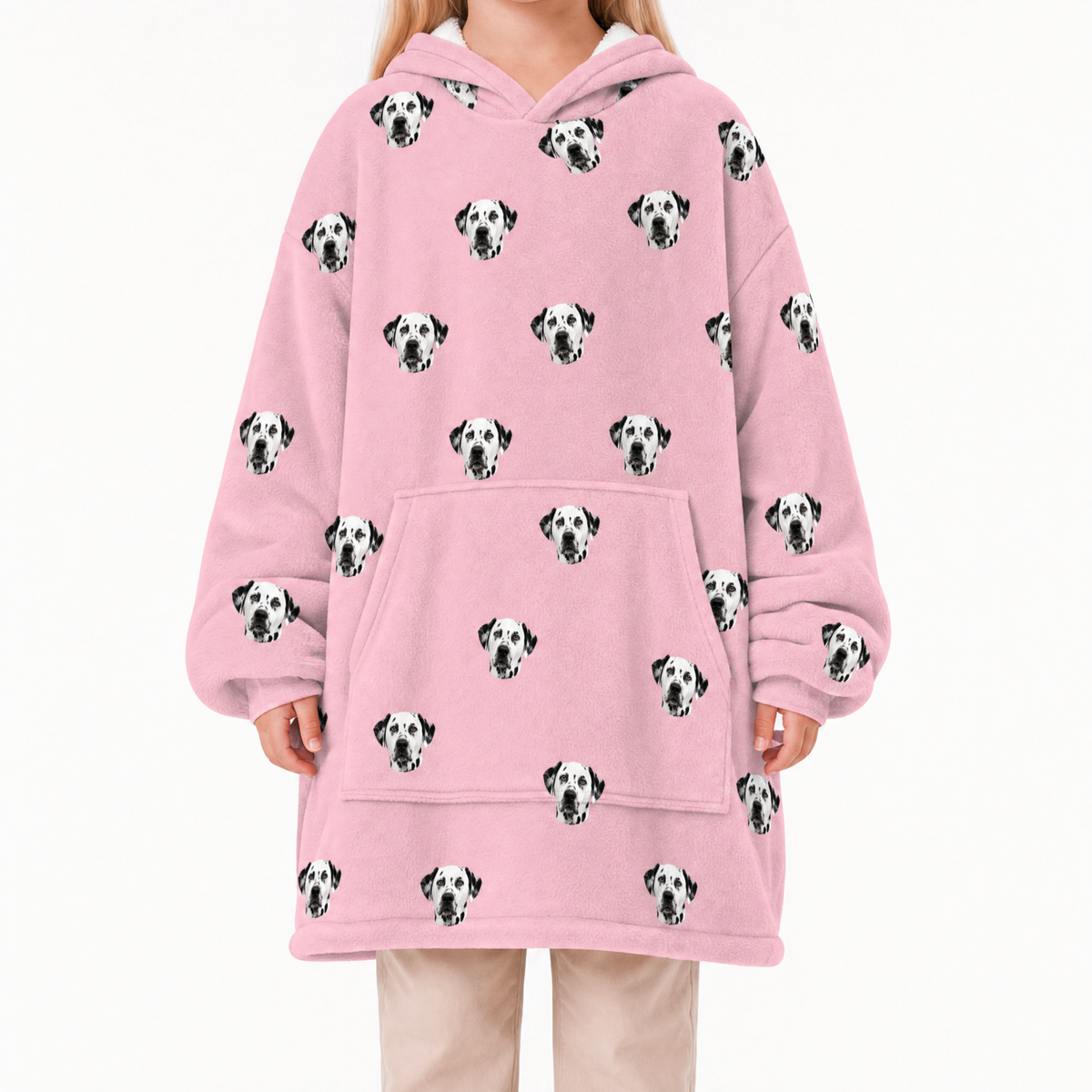 Pink blanket hoodie with Dalmatian dog pattern worn by a person on a white background