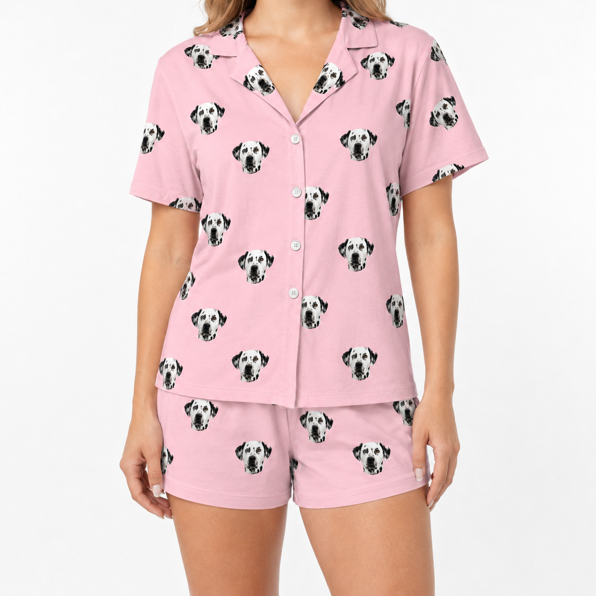 Pink pajama set with dalmatian pattern on a white background