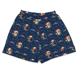 A pair of navy blue boxer briefs featuring a festive Christmas print with custom dog portraits, Santa hats, holly leaves, and the text 'CHRISTMAS WINTER'.