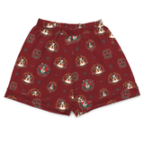 A pair of men's boxer shorts in a deep burgundy red, featuring an all-over repeating pattern of dog portraits framed in ornate circular medallions with small decorative motifs.