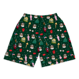 A pair of dark green shorts featuring a festive Christmas-themed print with Australian Shepherd dogs, pink misty mountains, red houses, Christmas trees, and holiday figures.