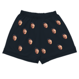 Black pajama shorts with elastic waist and repeating tongue-out face prints[BlackPajamaShorts]