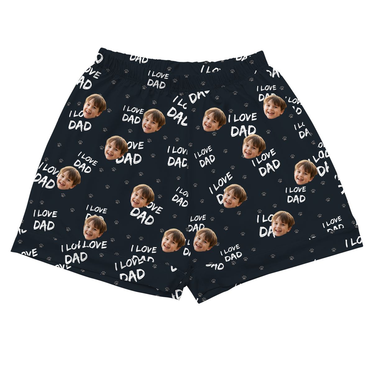 A pair of athletic or pajama shorts with an elastic waistband, made from a navy blue or dark gray fabric. The fabric is patterned with the repeating light gray text "I LOVE DAD" and small paw prints.