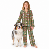 A young girl stands barefoot next to a large Australian Shepherd dog, wearing matching green plaid pajamas with a dog-themed print. The pajamas feature a green background with a plaid pattern and illustrations of dogs, bows, and a pink ribbon.