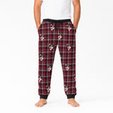 Plaid pajama pants with dog pattern worn by a person on a white background