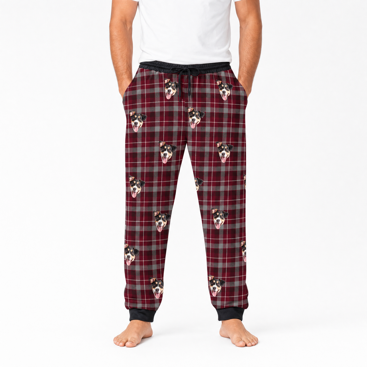 Plaid pajama pants with dog pattern worn by a person on a white background
