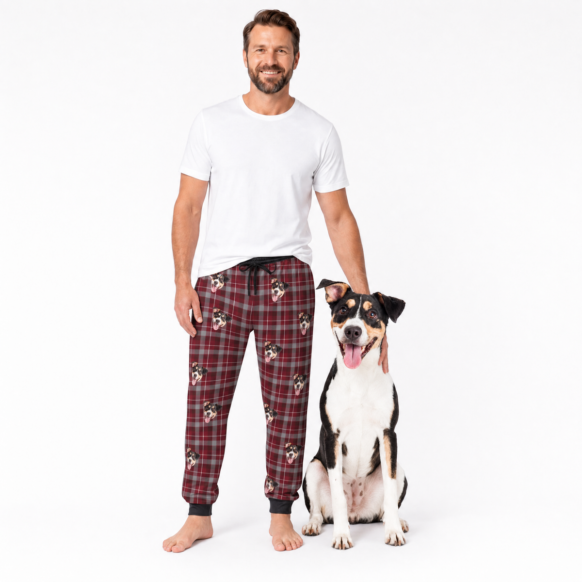Man wearing plaid pajama pants with a dog on a white background