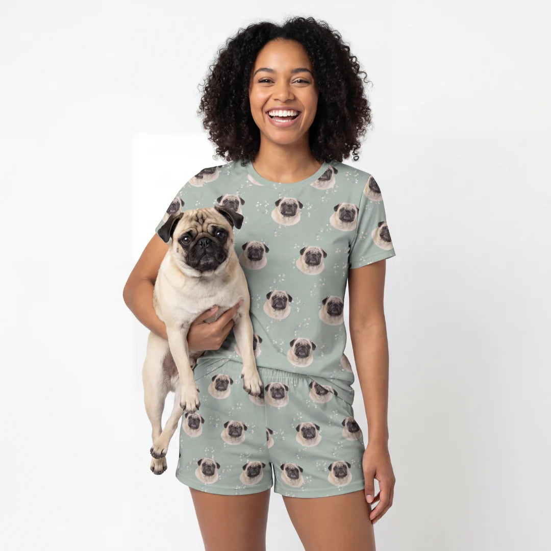Woman wearing a pug-themed t-shirt and shorts set, holding a pug dog. [VintageBloom]