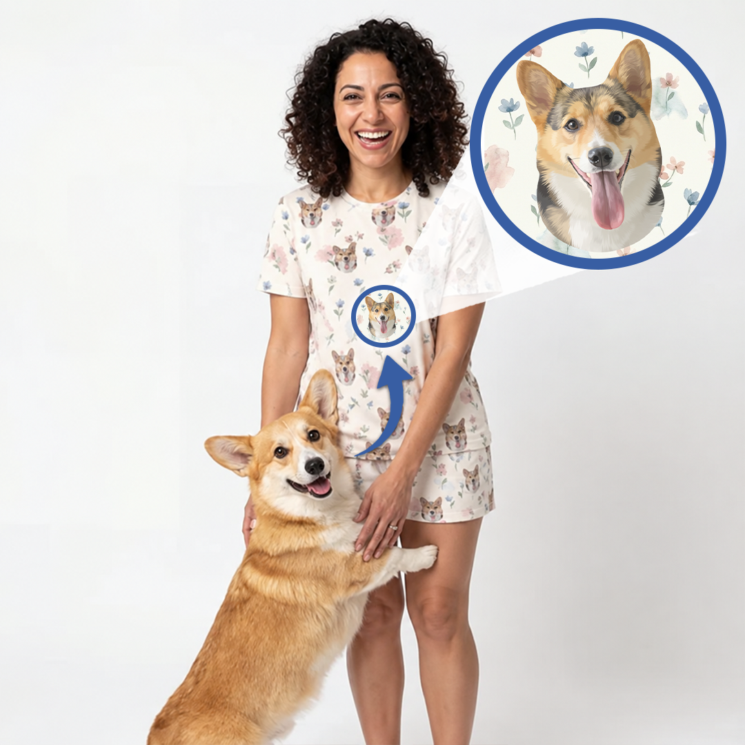 A woman wearing a custom-printed short-sleeve pajama top and matching shorts stands with a corgi dog against a white studio background. A circular inset shows the original dog photo from which the custom print is derived, with a blue arrow pointing to the matching print on the pajamas.