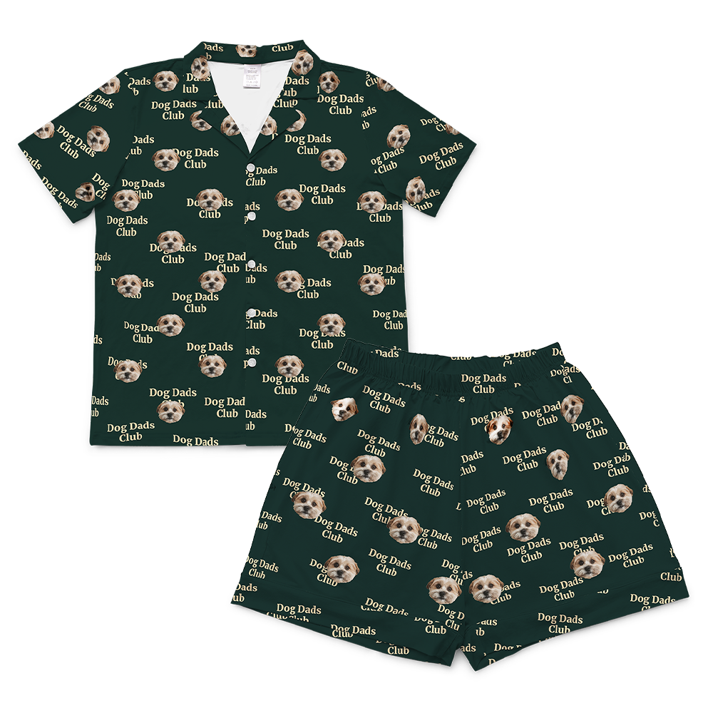 A matching short-sleeve pajama set (top and shorts) rendered in a dark green fabric. The entire set is covered in a repeating pattern featuring alternating elements: the phrase "Dog Dads Club" in text, and smiling headshots dog.