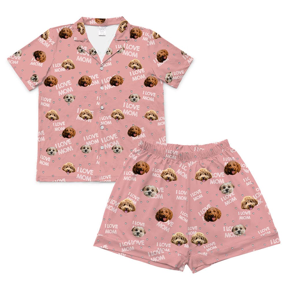 Light pink short-sleeve pajama set, including a button-down top and matching shorts, both patterned with the phrase "I LOVE MOM," small hearts, and the faces of three different dogs.