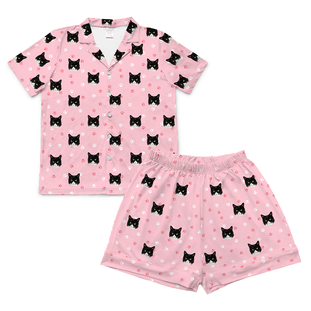 Light pink paws pajama set with black cat pattern on a white background