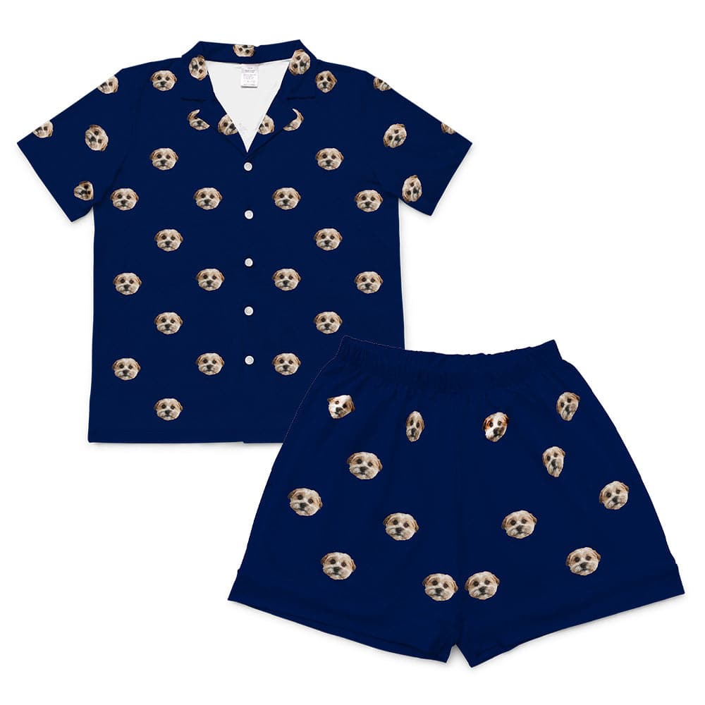 Solid navy short-sleeve pajama set with a button-down top and matching shorts, featuring an all-over pattern of a single dog’s face.