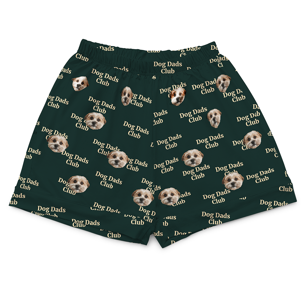 Dark green shorts with 'Dog Dads Club' text and dog images on a white background