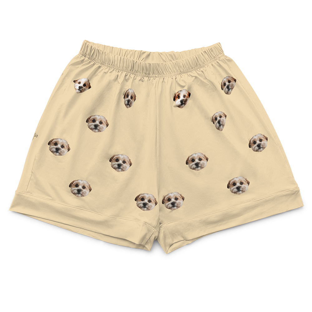 These are pajama shorts in a butter yellow color with repeating pet faces on them[ButterYellowPajamaShorts]