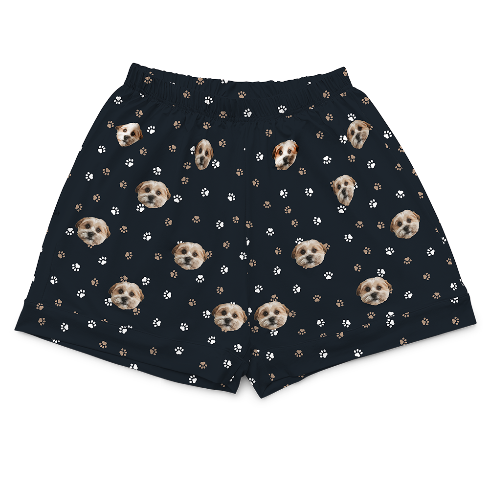 Black pajama shorts patterned with white and brown paw prints and the repeating custom photo head of a single, light-colored dog.
