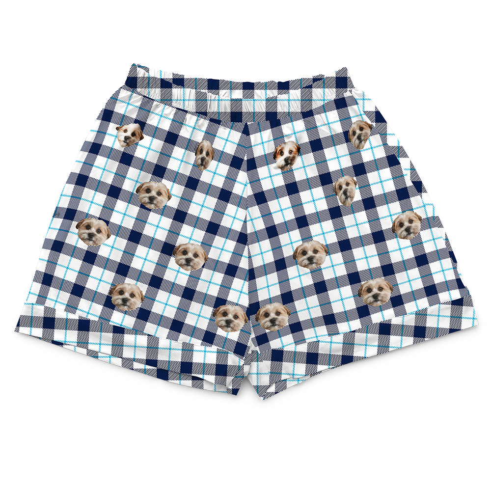 Navy blue, light blue, and white plaid pajama pants featuring a repeating pattern of a dog face.