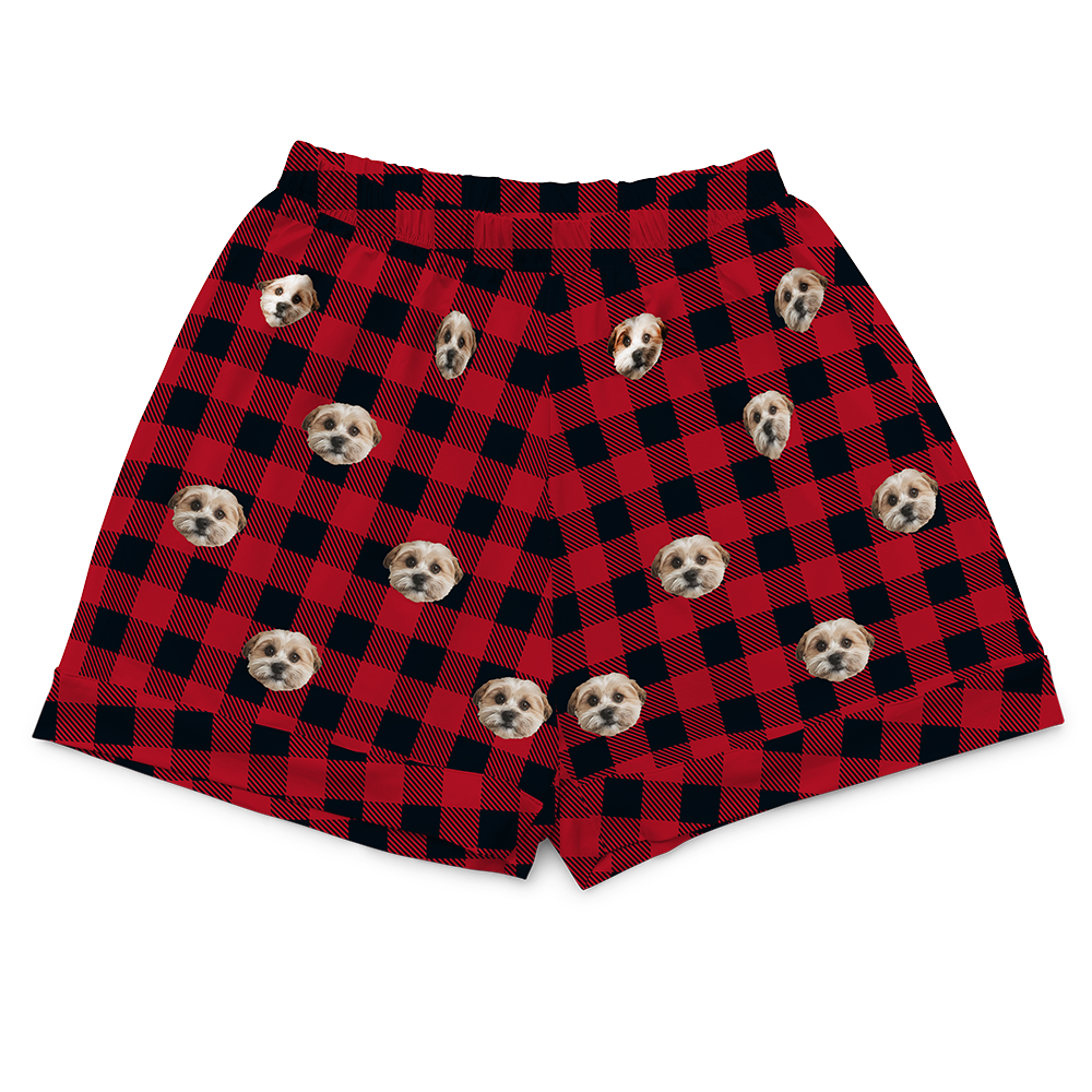 Red and black checkered shorts with dog pattern on a white background