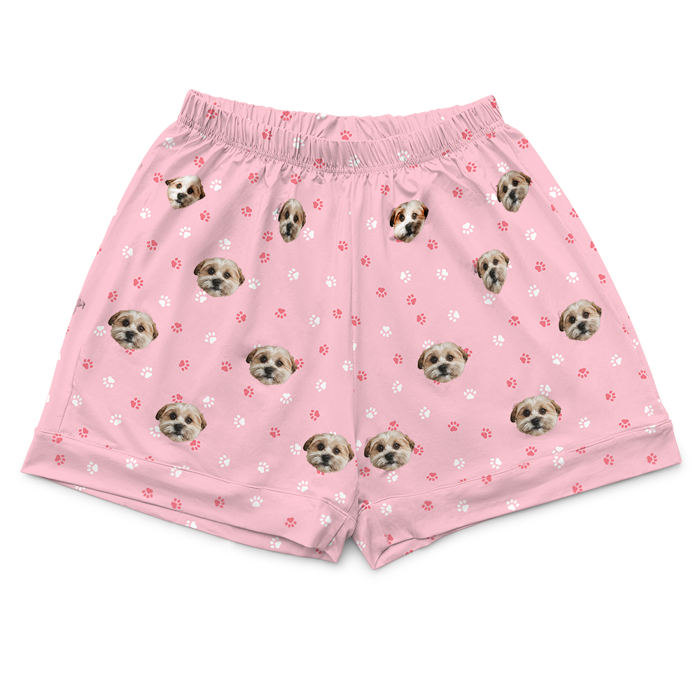 These are pajama shorts in a pink color with repeating pet faces on them[PajamaShorts]
