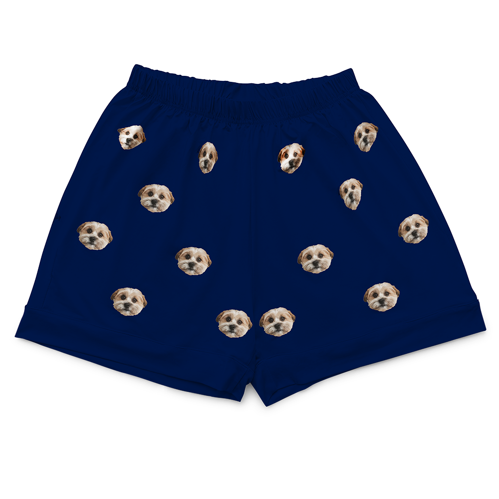 Solid navy pajama shorts with an elastic waistband, featuring an all-over pattern of a single dog’s face.