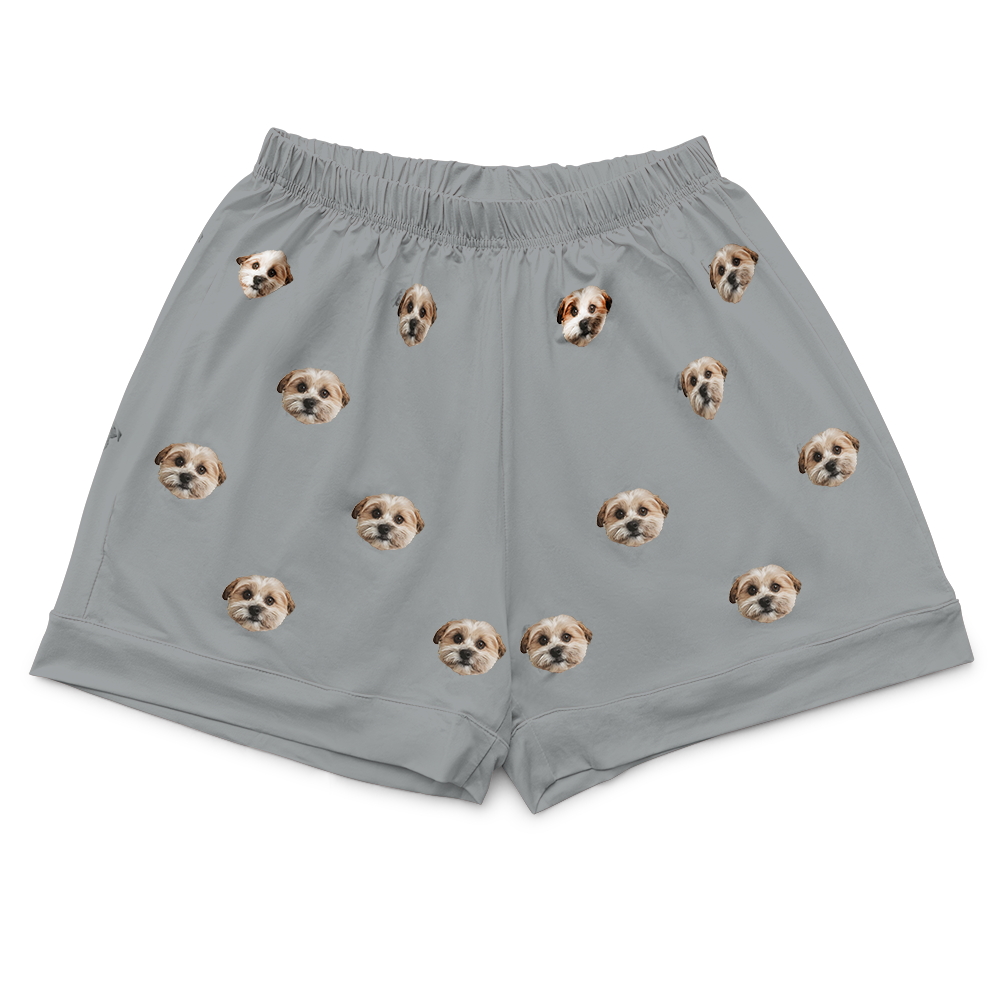 Slate grey pajama shorts featuring a repeating pattern of small dog faces printed across the fabric.