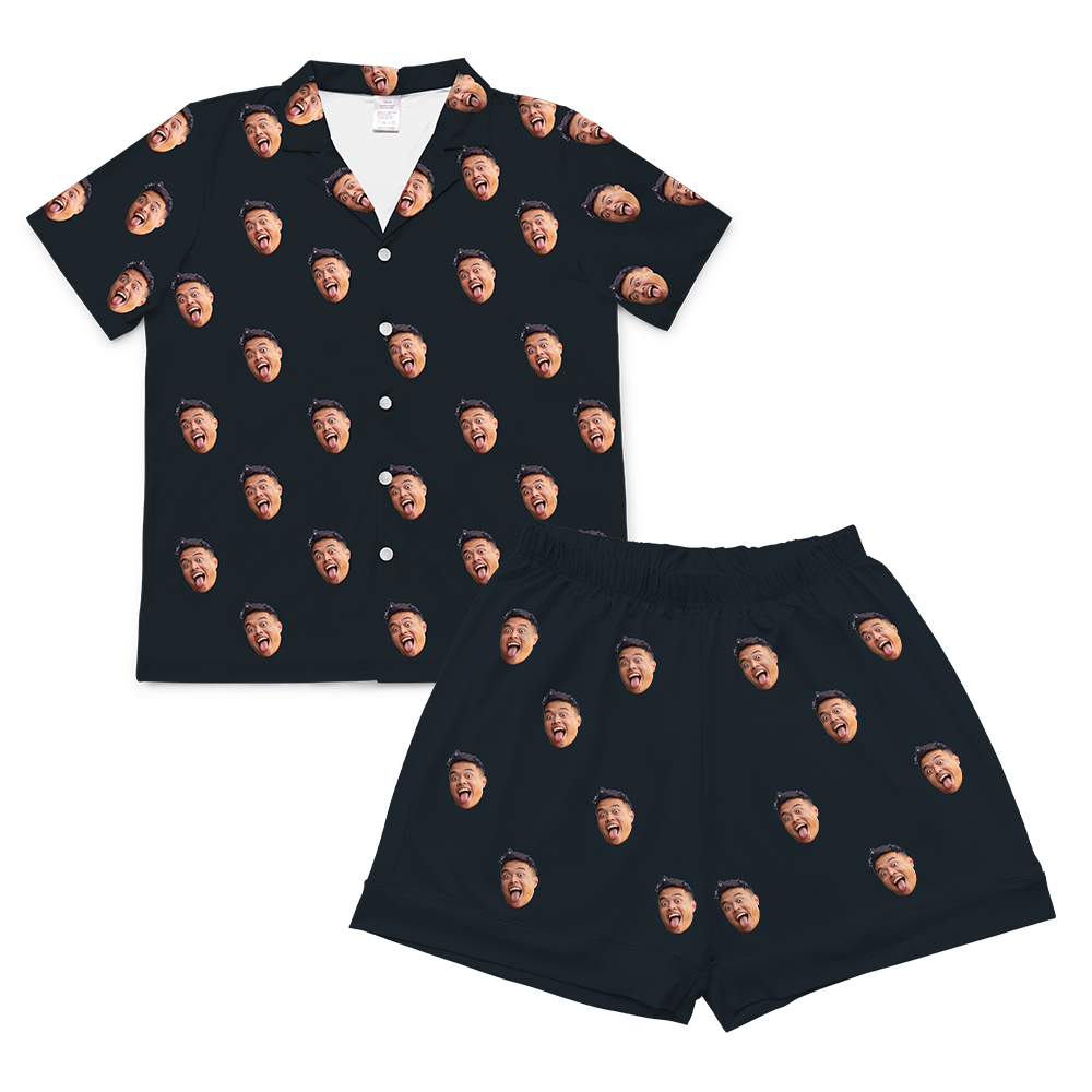 A two-piece set of short-sleeve pajamas in a solid black or dark navy color. The pajamas are customized with multiple small, repeating images of a man's face with a wide-open, laughing expression, covering the entire fabric of both the shirt and the shorts.