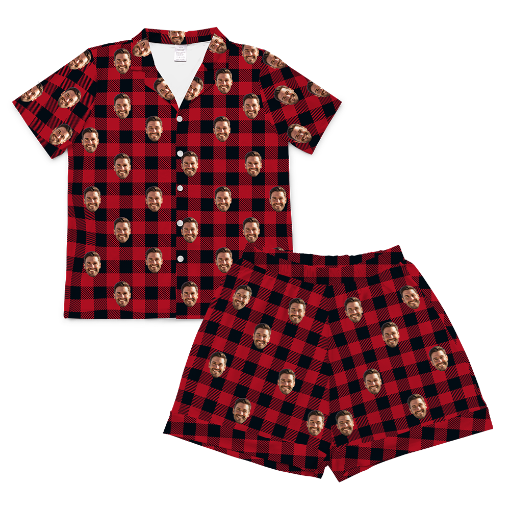 A two-piece set of short-sleeve pajamas in a red and black buffalo plaid pattern. The pattern is customized with multiple small, repeating images of a man's smiling face covering the entire fabric of both the shirt and the shorts.