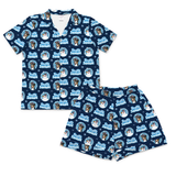 A two-piece short-sleeve pajama set consisting of a button-front collared shirt and matching shorts, both in a deep burgundy red fabric with an all-over print of dog faces inside circular frames.